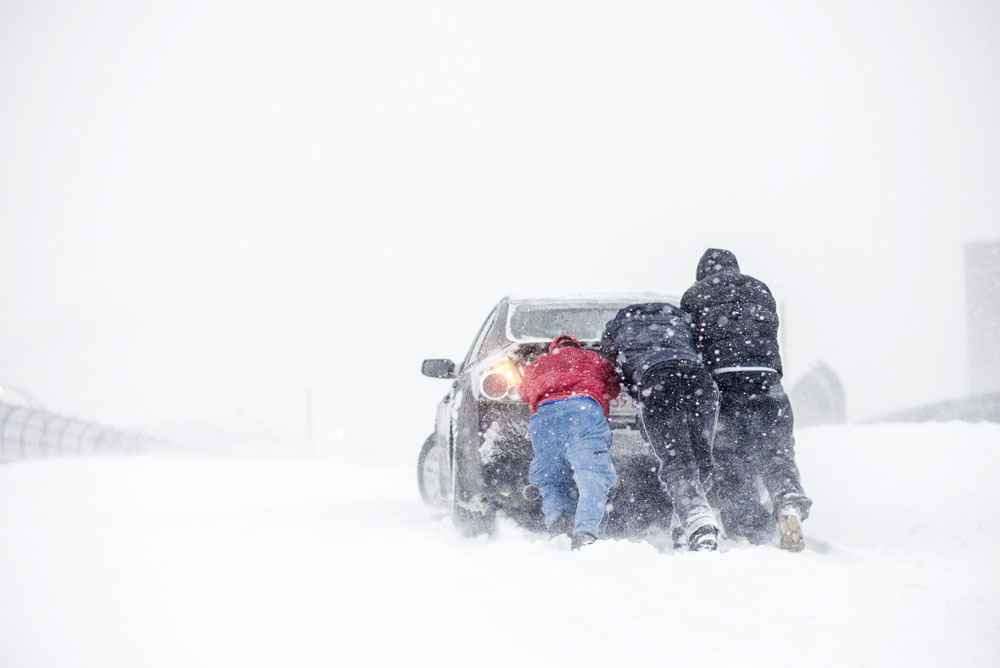 Pushing a car on Cambridge St in Boston Snowpocalypse Nemo